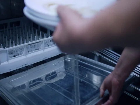 Placing dishes in dishwasher Stock Footage 78374049