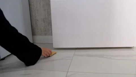 Placing Door Stopper under Door on Marble Floor in Home Interior Stock Footage 302688022