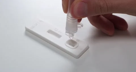 Placing drops of liquid on self test strip, close up Stock Footage 155074331