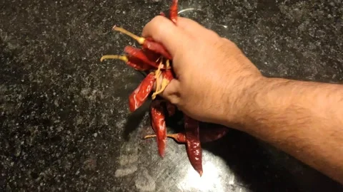 Placing dry red chilies in kitchen desk Stock Footage 152304623