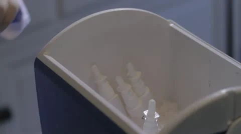 Placing eye droppers in a freezer Stock Footage 20446459