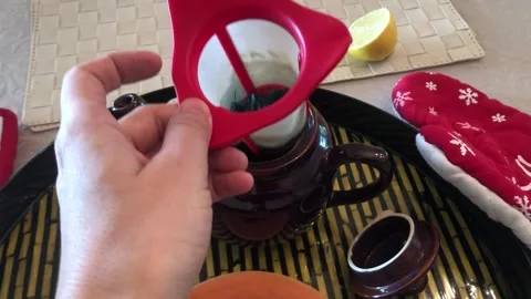 Placing Filter In Teapot Tea Preparation Process Close-Up Stock Footage 331944371