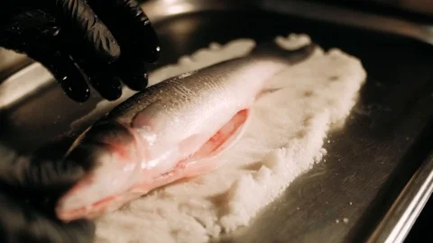 Placing fish in the salt crust Stock Footage 125458629