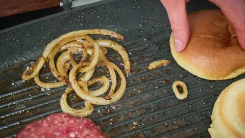 Placing, flipping, and removing bun bread from a grilling pan in 4K. Stock Footage 153755697