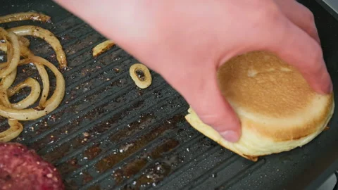 Placing, flipping, and removing bun bread from a grilling pan in 4K. Stock Footage 153755919