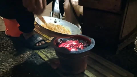 Placing Frying Pan over Hot Burning Anglo Charcoal Stove Stock Footage 339622654