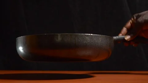Placing a frying pan on a table Stock Footage 276594203