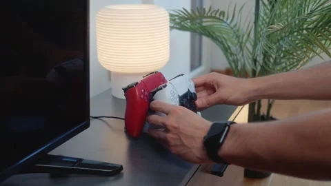 Placing Gaming Controllers on Charging Dock Station Stock Footage 342333359