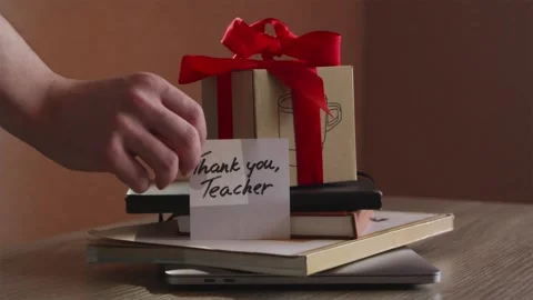 Placing gift box and Thank You Teacher card on desk Stock Footage 340139213
