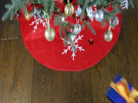 Placing gift boxes under christmas tree Stock Footage 73092193