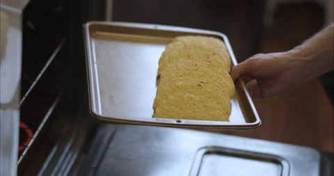 Placing hard shell corn tortillas in oven on a baking sheet Stock Footage 155547296