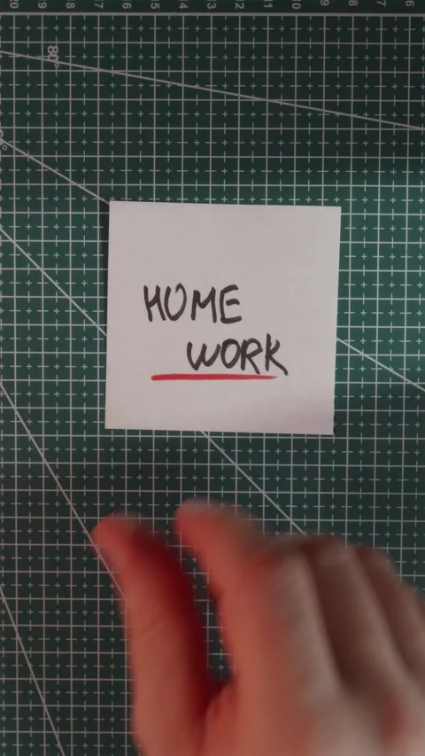 Placing Home Work paper note on green grid cutting mat Stock Footage 341246113