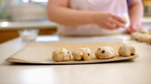 Placing hot cross buns on baking sheet in part slow motion 4K Stock Footage 48845933