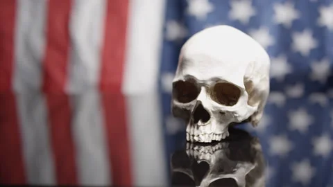 Placing a human skull on American background Stock Footage 141530832