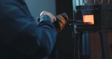 Placing iron into a hot forge Stock Footage 105295610