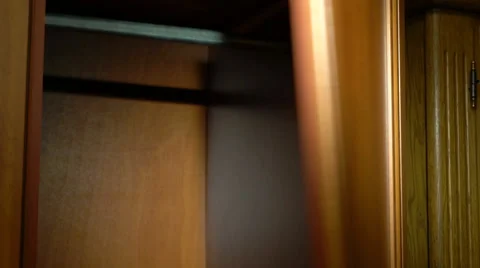 Placing a jacket into a wardrobe Stock Footage 61440874