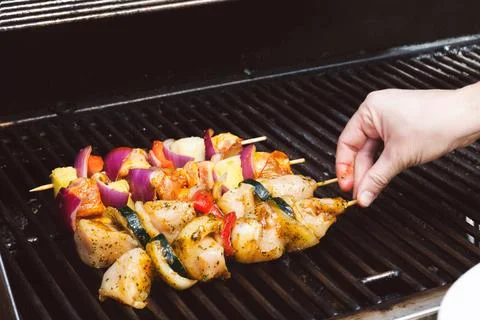 Placing kababs on the bbq Stock Photos