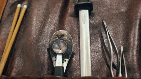 Placing a knife in chef's leather roll bag Stock Footage 125026640