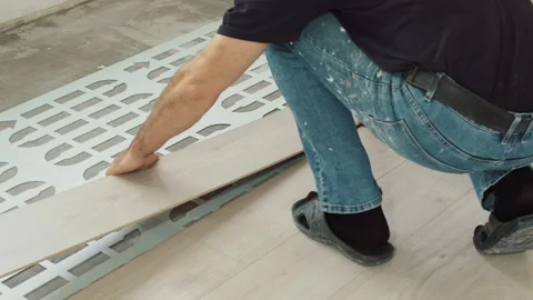 Placing Laminate Plank onto Underlayment Stock Footage 321749839