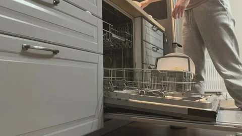 Placing Large Plates Into Lower Rack Of Dishwasher Kitchen Cleaning Workflow Stock Footage 336442457