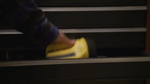Placing large retro flashlight in too small of toolbox drawer Stock Footage 277019035