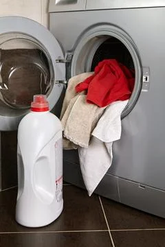 Placing laundry in the washing machine in the laundry room Stock Photos