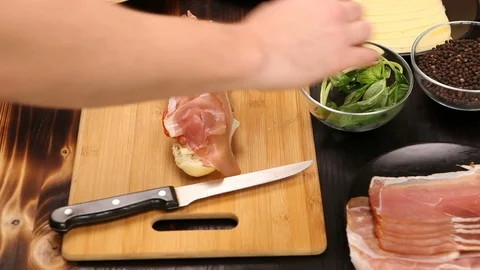 Placing letuce on healthy sandwich in the kitchen Stock Footage 86232702