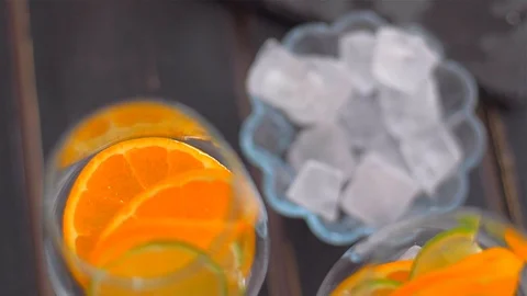 Placing lime slice and ice in a glass  . Preparing cocktails Stock Footage 110046447