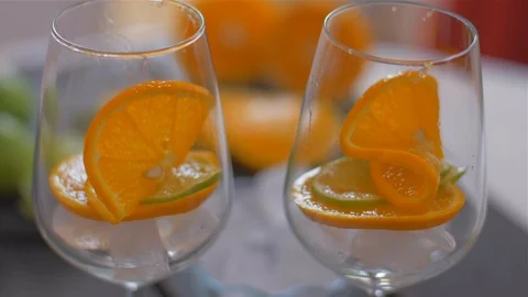 Placing lime slice in a glass with ice . Preparing cocktails Stock Footage 110044003