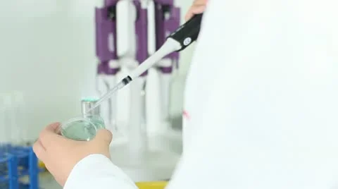 Placing liquid in a glass container Stock Footage 11855186