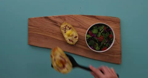 Placing a loaded potato on a platter 1 Stock Footage 132149185