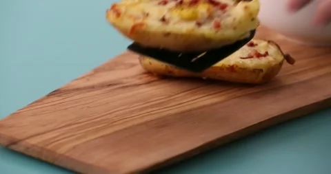 Placing a loaded potato on a platter 2 Stock Footage 132149169