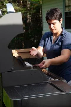 Placing meat on the bbq Stock Photos
