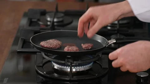 Placing the meatballs in the pan Stock Footage 183569935