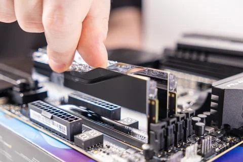 Placing memory module, ram installation process, motherboard assembly, hand a Stock Photos