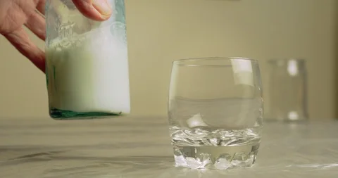 Placing Milk Bottle on Table Stock Footage 94628094