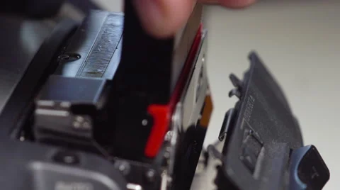 Placing a Mini DV tape in a camera deck in extreme slow motion. Stock Footage 62530872