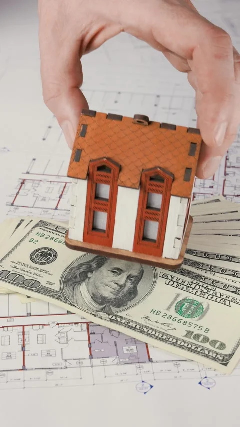 Placing a model house on dollar bills Stock Footage 288984978