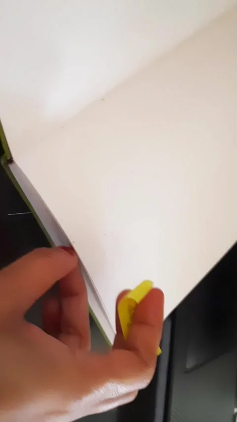 Placing Monday Sticky Note in Notebook Before Working on Laptop Stock Footage 340458477