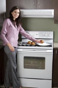 Placing muffins Stock Photos