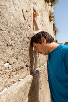 Placing a note in the wailing wall Stock Photos