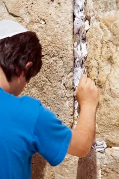 Placing a note in the wailing wall Stock Photos