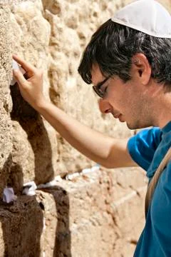 Placing a note in the wailing wall Stock Photos