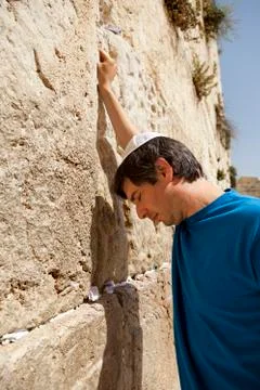 Placing a note in the wailing wall Stock Photos