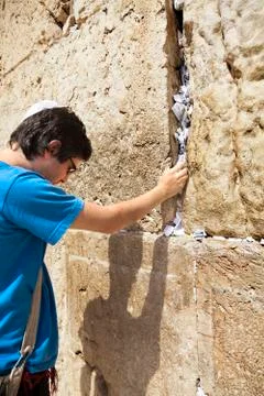 Placing a note in the wailing wall Stock Photos