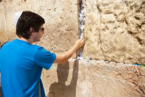 Placing a note in the wailing wall Stock Photos