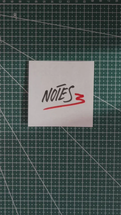 Placing Notes paper slip on green cutting mat flat lay Stock Footage 341246127