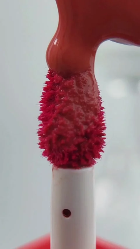 Placing or applying lip tint onto the brush tip slowly. Close up view, prec.. Stock Footage 332227375