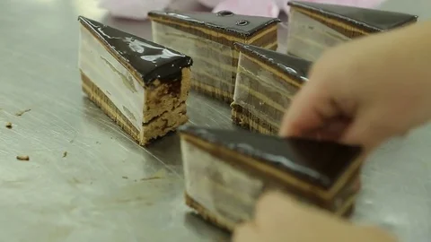 Placing paper around cake slices Stock Footage 77051967