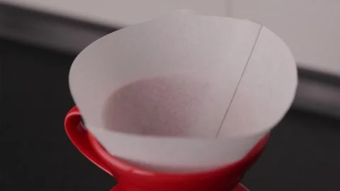 Placing paper filter into red V60 dripper close-up Stock Footage 332720233